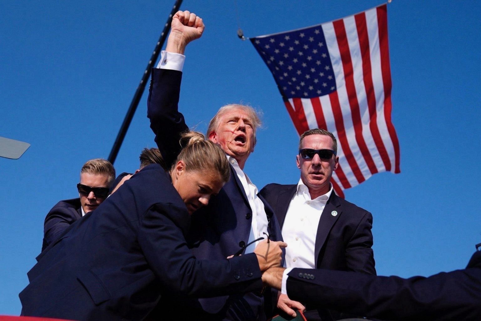 Donald Trump pumping fist in defiance post being shot in the head